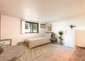 Thumbnail 4 of 7 - Mandan, ND Garden Grove Apartments.  a bedroom with a bed and a table