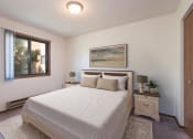 Thumbnail 2 of 7 - Mandan, ND Garden Grove Apartments. A bedroom with a bed and two night stands