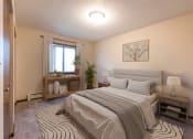 Thumbnail 4 of 10 - a bedroom with a bed and window. Bismarck, ND Newgate Apartments