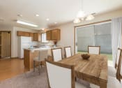Thumbnail 3 of 11 - Bismarck Pebble Creek Apartments.with a glass sliding door that allows natural light to fill the space. The room showcases a well-appointed dining table, stylish seating, and a welcoming atmosphere for enjoyable meals and gatherings