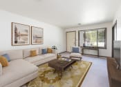 Thumbnail 1 of 10 - Bismarck, ND Riverpark Apartments The room features large windows that offer scenic views of the surrounding area, comfortable seating, and modern decor. The dark wood trim and furnishings bring the room to life with highly contrasting colors