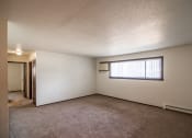 Thumbnail 6 of 17 - Bismarck, ND Rosser Apartments. an empty living room with a large window
