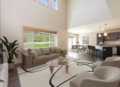 Thumbnail 2 of 11 - Bismarck, ND Stonefield Townhomes. The large room showcases comfortable seating, modern decor, and natural lighting, creating a welcoming and relaxing space for residents.