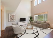 Thumbnail 3 of 11 - Bismarck, ND Stonefield Townhomes. The large room showcases comfortable seating, modern decor, and natural lighting, creating a welcoming and relaxing space for residents.