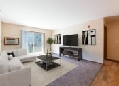 Thumbnail 2 of 16 - Bright Living Room Area at Stonefield Apartments in Bismarck, ND