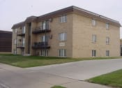 Thumbnail 6 of 6 - a large brick apartment building with balconies