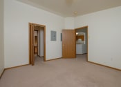 Thumbnail 22 of 26 - a master bedroom with a closet leading to a bathroom. Fargo, ND Bridgeport Apartments
