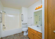 Thumbnail 18 of 26 - a bathroom with a sink and a toilet and a shower. Fargo, ND Bridgeport Apartments