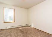 Thumbnail 10 of 19 - Grand Forks, ND Bristol Park Apartments. a bedroom with white walls and a window