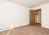Thumbnail 11 of 19 - Grand Forks, ND Bristol Park Apartments. a bedroom with a closet and carpeted floor