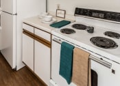 Thumbnail 13 of 19 - Grand Forks, ND Bristol Park Apartments. a kitchen with white appliances and white cabinets