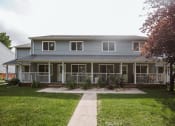 Thumbnail 19 of 19 - Grand Forks, ND Bristol Park Apartments.a house with a blue siding and a green lawn