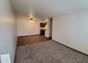 Thumbnail 10 of 13 - the living room and kitchen of an empty apartment.Fargo, ND Brookfield Apartments