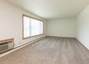 Thumbnail 16 of 34 - an empty living room with carpet and a large window