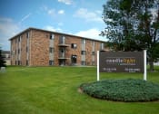 Thumbnail 13 of 13 - a large brick building with a sign in front of it. Fargo, ND Candlelight Apartments