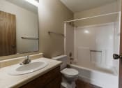Thumbnail 10 of 11 - Grand Forks, ND Carling Manor Apartments. a bathroom with a sink toilet and bathtub