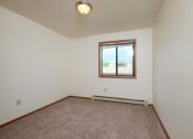 Thumbnail 31 of 41 - a bedroom with carpet and a window. Fargo, ND Carlton Place Apartments