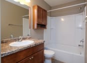 Thumbnail 25 of 41 - a bathroom with a sink toilet and bath tub. Fargo, ND Carlton Place Apartments