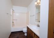 Thumbnail 29 of 41 - an empty bathroom with a sink toilet and shower. Fargo, ND Carlton Place Apartments
