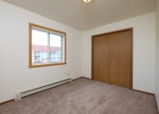 Thumbnail 27 of 41 - a bedroom with carpet and a window. Fargo, ND Carlton Place Apartments