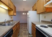 Thumbnail 21 of 41 - a kitchen with a stove sink and refrigerator. Fargo, ND Carlton Place Apartments