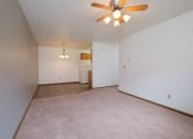 Thumbnail 19 of 41 - an empty living room with a ceiling fan and white walls. Fargo, ND Carlton Place Apartments