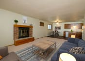 Thumbnail 8 of 18 - a living room with a couch and a coffee table and a fireplace. Fargo, ND Cedars 2 Apartments