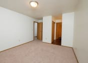 Thumbnail 9 of 13 - an empty bedroom with white walls and a beige carpet. Fargo, ND Cedars 2 Apartments