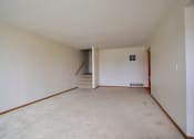 Thumbnail 13 of 20 - A living room with white walls and carpet