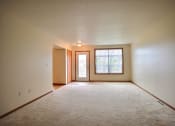 Thumbnail 12 of 20 - A living room of an empty house with a window
