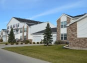 Thumbnail 1 of 20 - A row of Fargo, ND Charleswood Townhomes on the side of a street