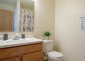 Thumbnail 10 of 20 - A bathroom with a toilet and a sink