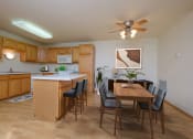 Thumbnail 3 of 20 - A kitchen and dining room with a wooden table and chairs. West Fargo, ND Charleswood Townhomes.