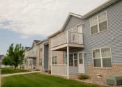 Thumbnail 20 of 20 - Arow of town homes with balconies and a sidewalk