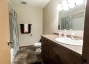 Thumbnail 12 of 19 - Grand Forks, ND Cherry Creek Apartments. A bathroom with tile flooring and hand towels