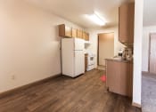 Thumbnail 13 of 19 - Grand Forks, ND Cherry Creek Apartments. A bedroom in unit 223 that has a window, white walls, and carpeted floors