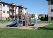 Thumbnail 9 of 10 - a playground in front of an apartment building. Fargo, ND Chestnut Ridge Apartments