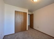 Thumbnail 7 of 10 - a bedroom with a closet and a door to a hallway