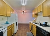 Thumbnail 5 of 10 - a kitchen with white appliances and wood cabinets. Fargo, ND Chestnut Ridge Apartment