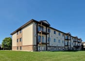 Thumbnail 10 of 10 - the exterior of an apartment building on a sunny day. Fargo, ND Chestnut Ridge Apartments