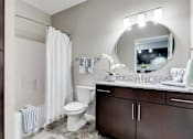 Thumbnail 69 of 83 - a bathroom with a white toilet and a sink. Circle Pines, MN Lexington Lofts