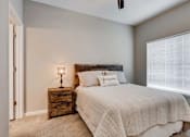 Thumbnail 57 of 83 - a bedroom with a bed and a window.  Circle Pines, MN Lexington Lofts