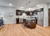 Thumbnail 53 of 83 - a kitchen with stainless steel appliances and a wooden floor. Circle Pines, MN Lexington Lofts