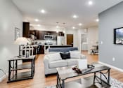 Thumbnail 51 of 83 - a living room with a couch and a table. Circle Pines, MN Lexington Lofts