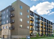 Thumbnail 79 of 83 - an image of an apartment building on a cloudy day. Circle Pines, MN Lexington Lofts