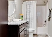 Thumbnail 50 of 83 - a bathroom with a sink and a toilet and a shower. Circle Pines, MN Lexington Lofts