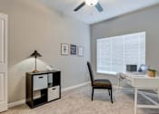 Thumbnail 48 of 83 - a bedroom with a desk and a chair and a window. Circle Pines, MN Lexington Lofts