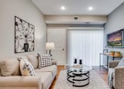 Thumbnail 43 of 83 - a living room with two couches and a glass coffee table. Circle Pines, MN Lexington Lofts