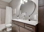 Thumbnail 42 of 83 - a bathroom with a sink and a toilet and a mirror. Circle Pines, MN Lexington Lofts