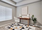 Thumbnail 40 of 83 - a home office with a large window and a desk with a chair. Circle Pines, MN Lexington Lofts
